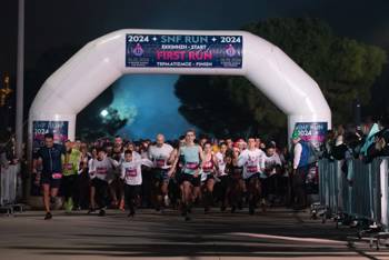 The runners of the SNF RUN 2024: FIRST RUN cross the starting line as the race begins.